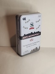 New – University Games Anti-Monopoly Game Travel Tin – Ages 8+ | 2-6 players