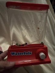 Original Waterfuls Classic Handheld Water Game – 6 Interchangeable Back Panels