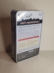 New – University Games Anti-Monopoly Game Travel Tin – Ages 8+ | 2-6 players